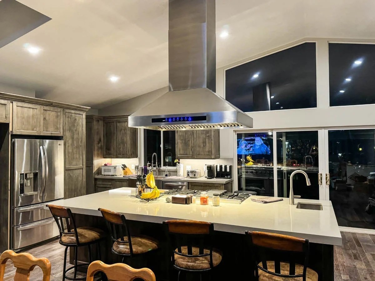 Island range hood over a kitchen island cooktop